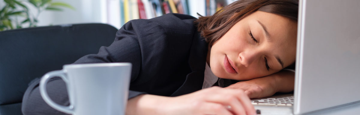 Workaholic Businesswoman Sleeping On Computer Keyboard