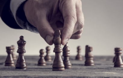 Wide Cropped Image Of A Human Hand Wearing Business Suit Moving Dark King Chess Piece