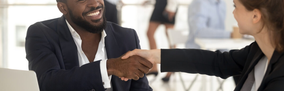 Happy African Manager Broker Handshaking Caucasian Client At Meeting