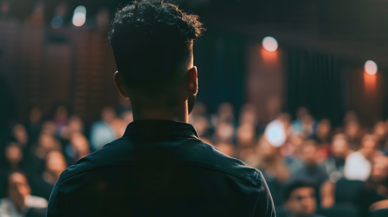 A Leadership Training Session In A Spacious Auditorium, With A Motivational Speaker Using Impactful Visuals To Inspire The Audience, Leadership, Conference Event, Blurred Backgroun