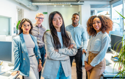 Confident Business Team Smiling In Modern Coworking Office