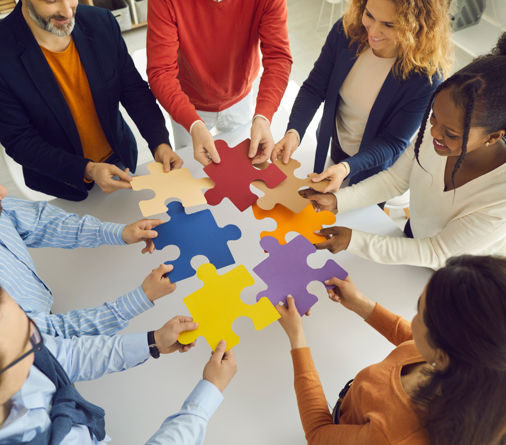 Business Team Joining Puzzle Parts As Metaphor For Teamwork And Finding Solution To Problem